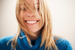 A smiling woman with eyes closed