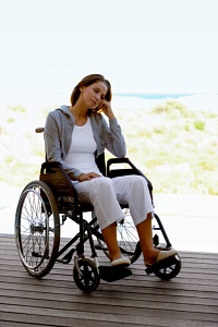 Woman in a wheelchair looking sad