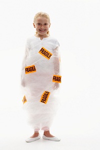 Child wrapped in plastic with fragile stickers
