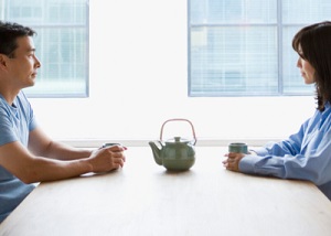 couple-facing-one-another-across-a-table