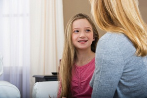 Girl sitting and talking with her mother