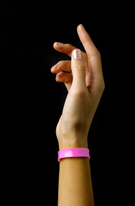 Hand wearing pink wristband
