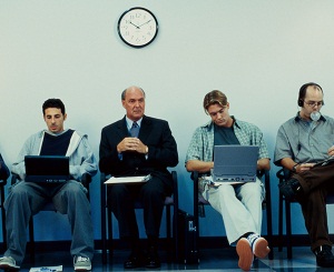 Men in waiting room with laptops