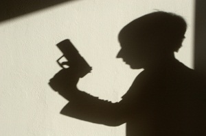 Silhouette of man with gun
