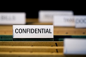 file folder labeled "confidential" in filing cabinet