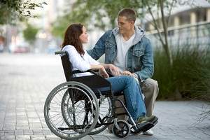Man talking to woman in wheelchair