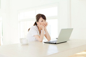 Worried woman sitting with laptop