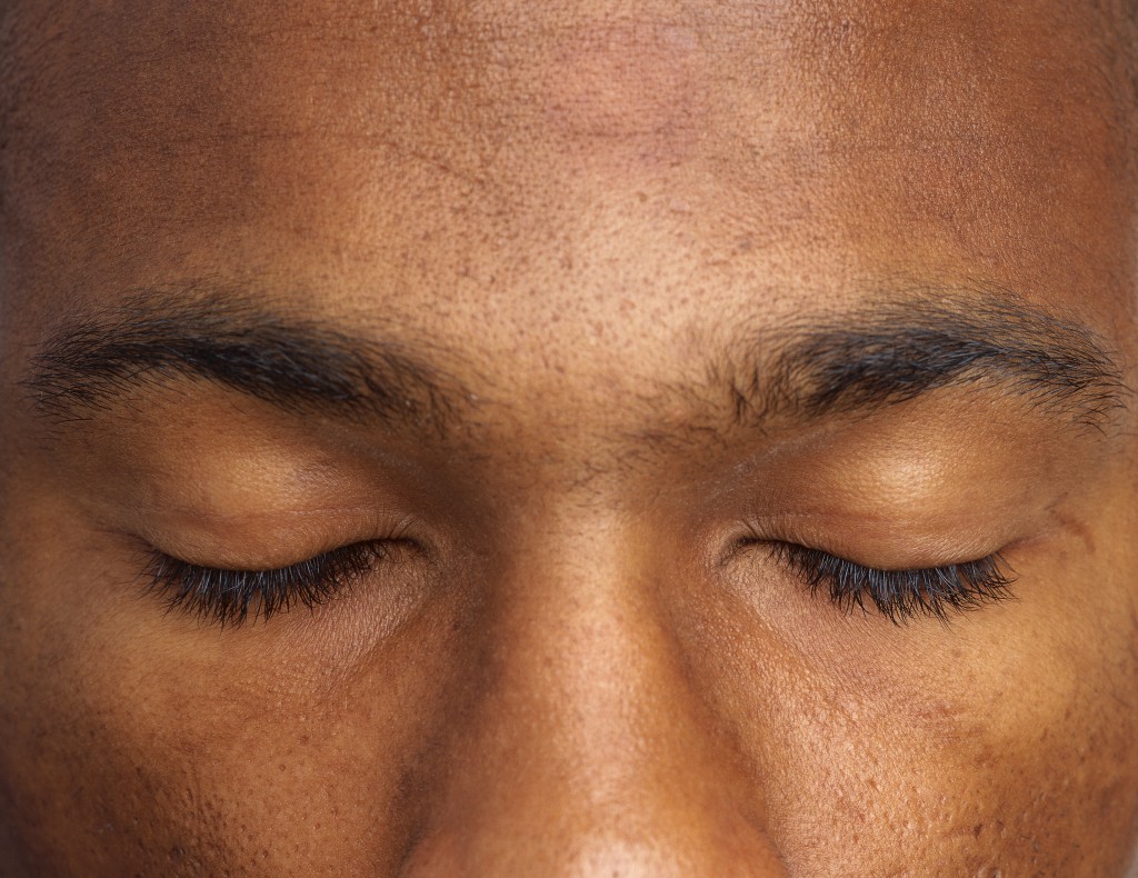close-up of a man's eyes shut