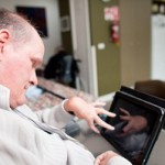 Disabled man using tablet