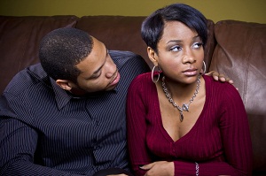 Husband and wife sitting on couch