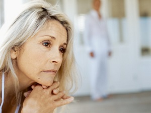 Mature woman stares blankly.