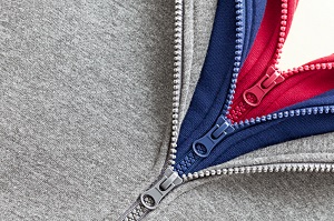 Three zippers being unzipped