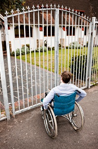 Man in wheelchair at gate