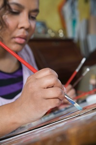 Woman sits painting