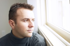 Headshot of man looking out window