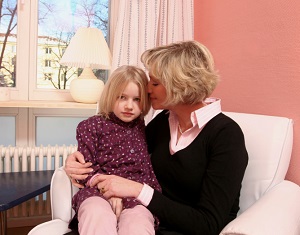 Mother with young daughter on lap