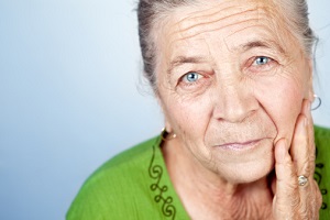 Senior woman looks thoughtfully at the camera