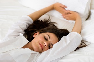 Woman stretching in bed