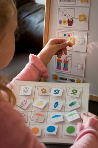 Young girl putting stickers on a board