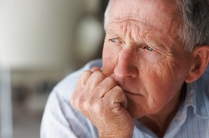 Older man sitting and thinking