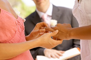 Two women exchanging wedding rings