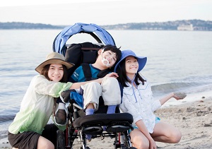 Two teen girls with disabled brother