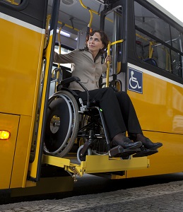 Woman exiting a public bus in her wheelchair