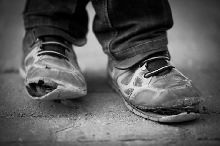 Child's feet in very old shoes