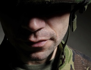Close up of soldier's face in shadows