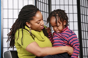 woman consoling her crying child