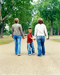 lesbian-parents-walking-with-child