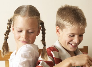 Young, curious girl looks at boy