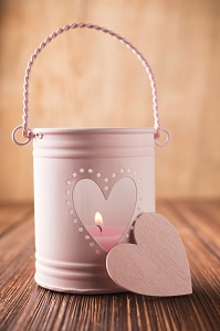 pink candle in heart pail holder