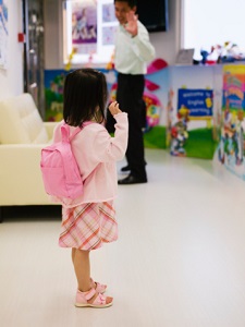 child waving at her father