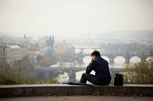 man in despair sitting on ledge