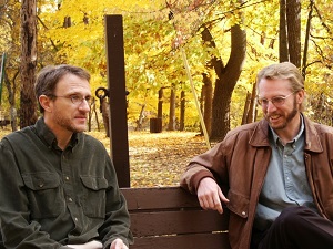two men chatting on park bench