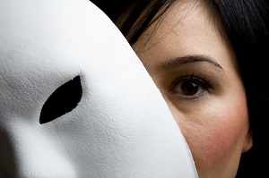 woman hiding behind mask