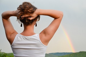 woman looking at rainbow