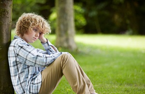 young boy sitting alone