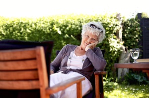 aging woman relaxing on patio