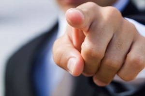 close-up of a man in a suit pointing