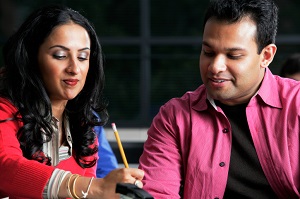 man and woman writing down ideas