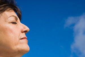 woman with eyes closed in the sunlight