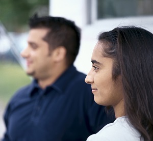 Smiling young adult woman and man