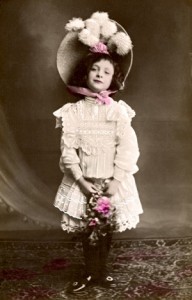 Young girl in frilly dress and flowered hat