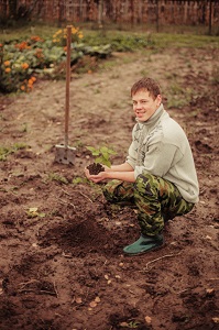 man in camouflage pants gardening