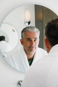 Mature Man Looking in Mirror