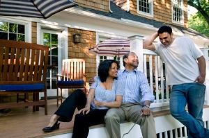 parents sitting on patio with their adult son