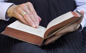 woman combing through bible