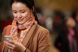 young woman texting parents